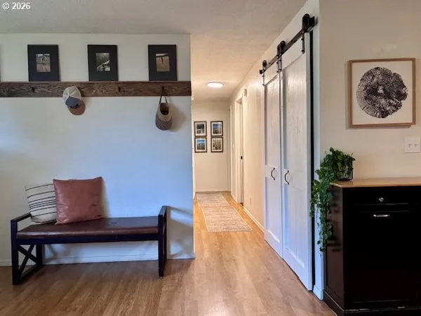 a hallway with furniture and wooden floor