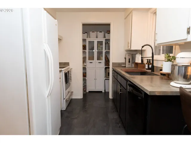 a kitchen with a sink and a refrigerator