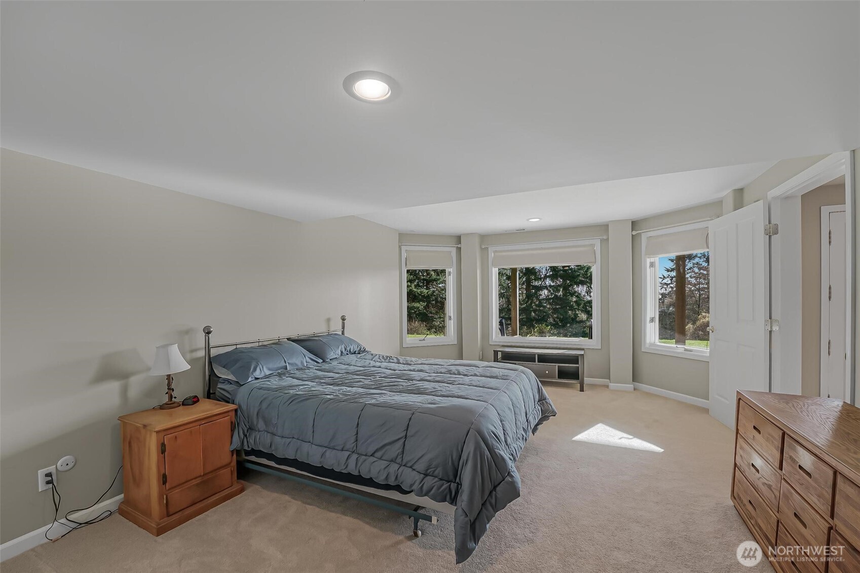 528 Waynes Ridge Circle Camano Island, WA 98282 - Photo 29 of 40 a bedroom with a large bed and windows