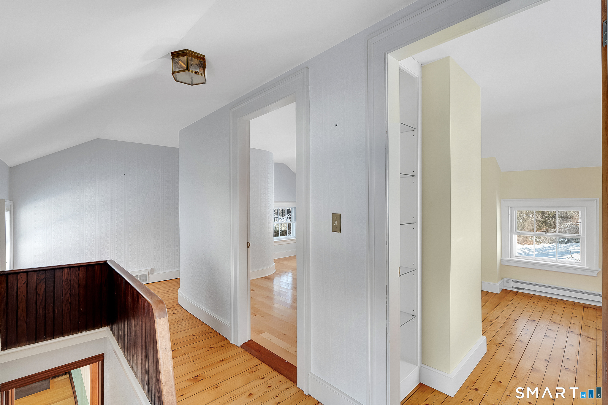 110 Freeman Road Middletown, CT 06457 - Photo 18 of 33 a view of a hallway to a livingroom with wooden floor and windows