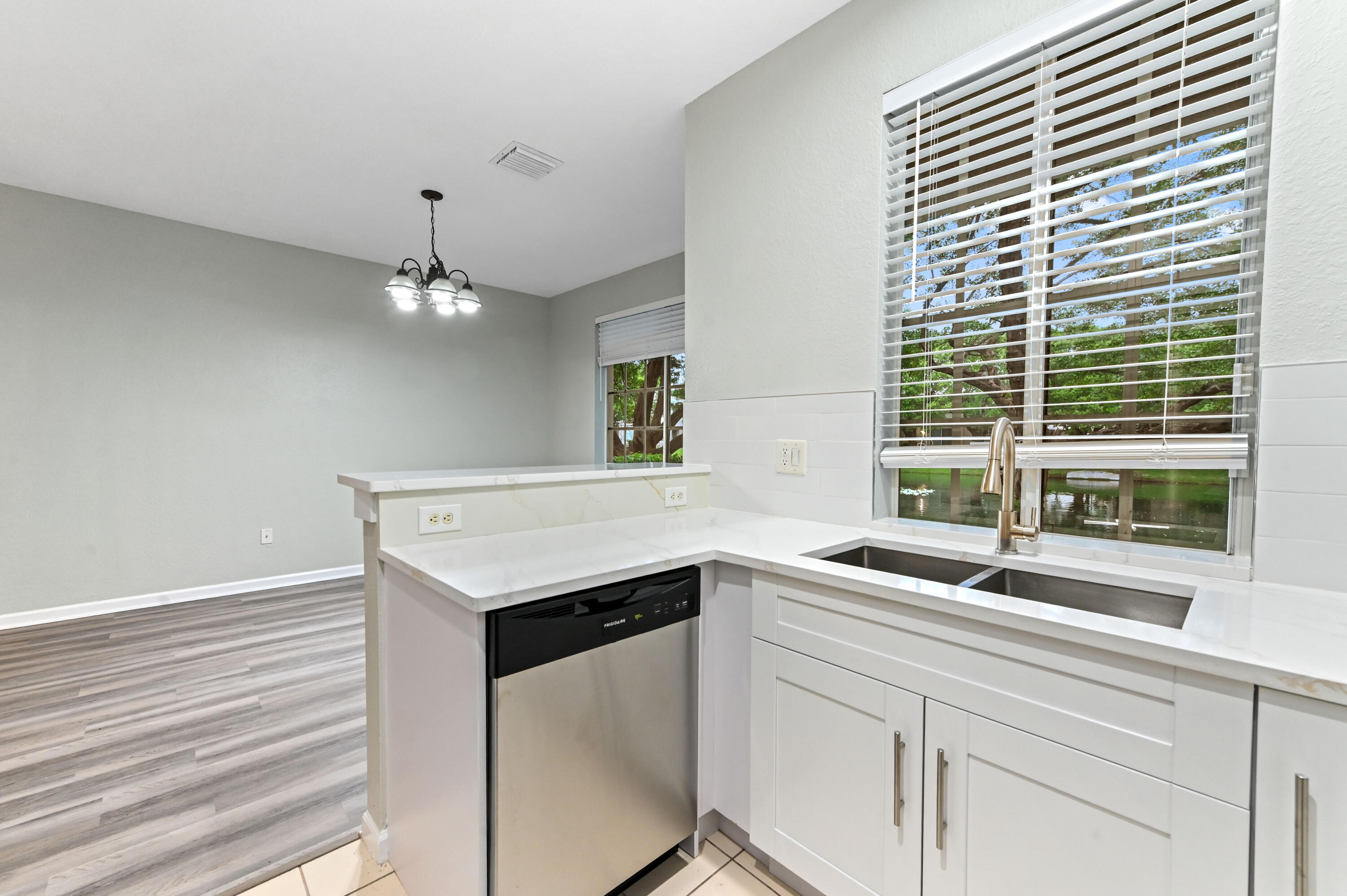 975 Tortuga Drive Riviera Beach, FL 33404 - Photo 11 of 29 a kitchen with a sink and a window