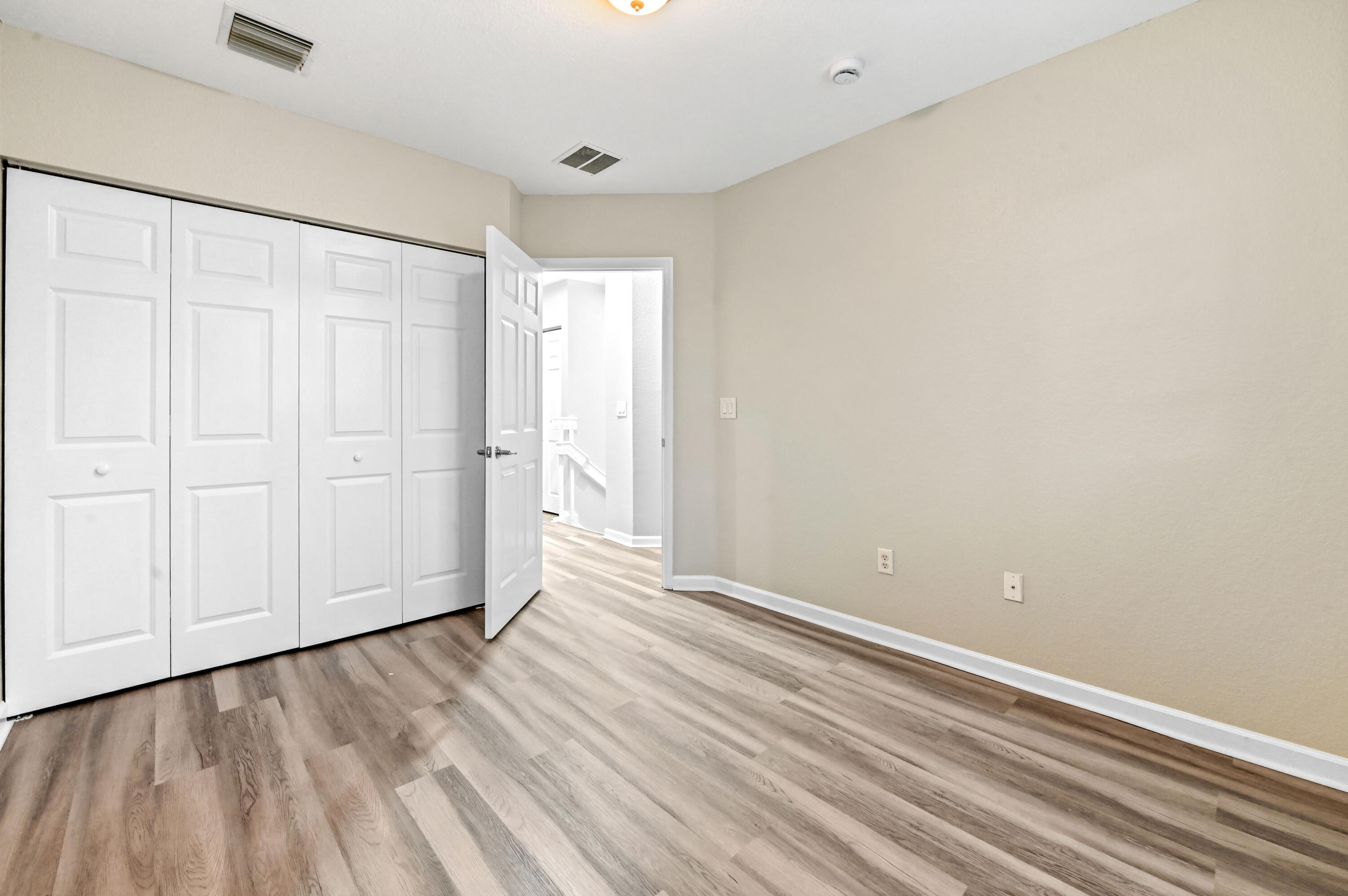 975 Tortuga Drive Riviera Beach, FL 33404 - Photo 17 of 29 a view of an empty room with wooden floor