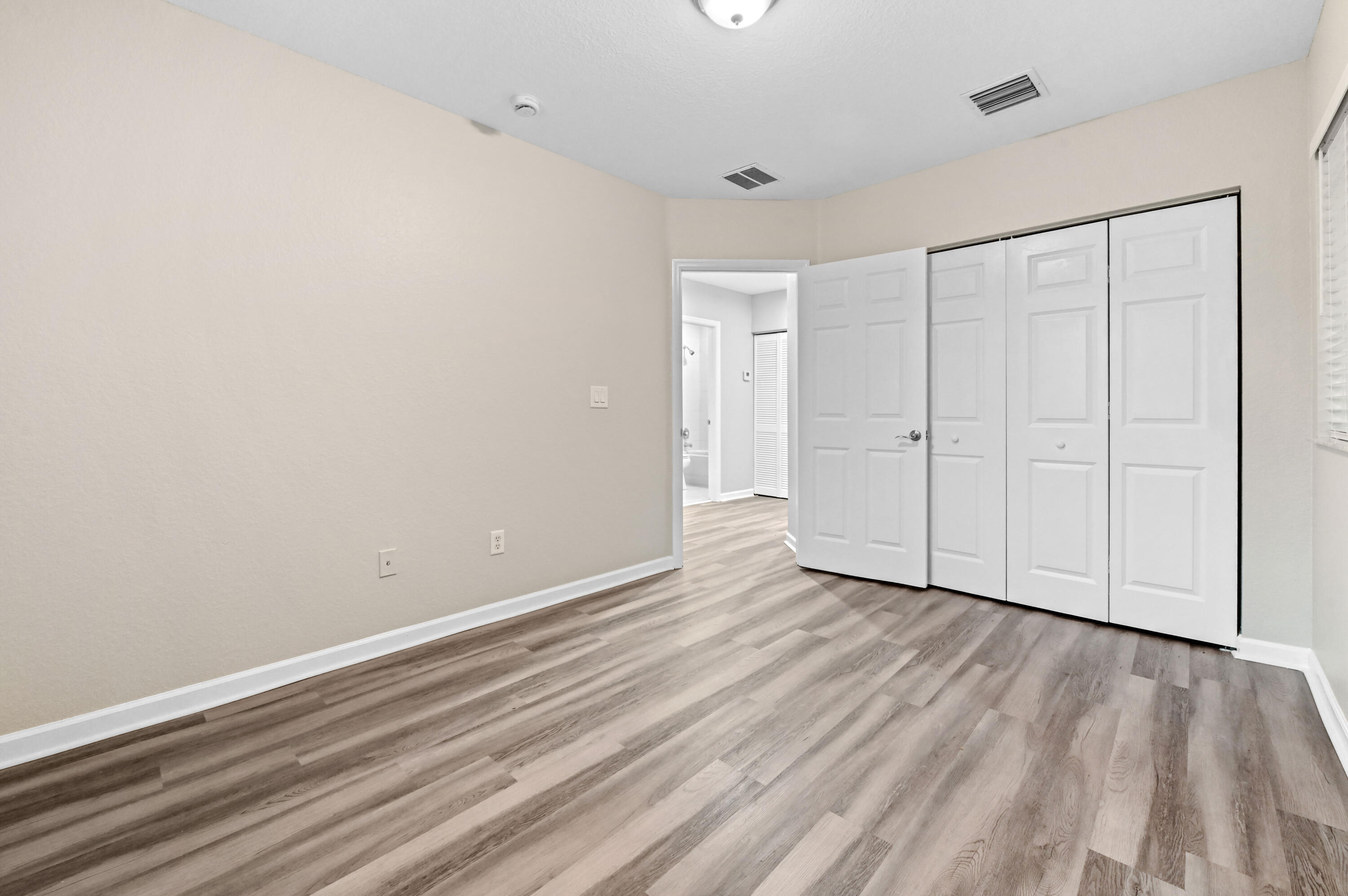 975 Tortuga Drive Riviera Beach, FL 33404 - Photo 19 of 29 a view of an empty room with wooden floor