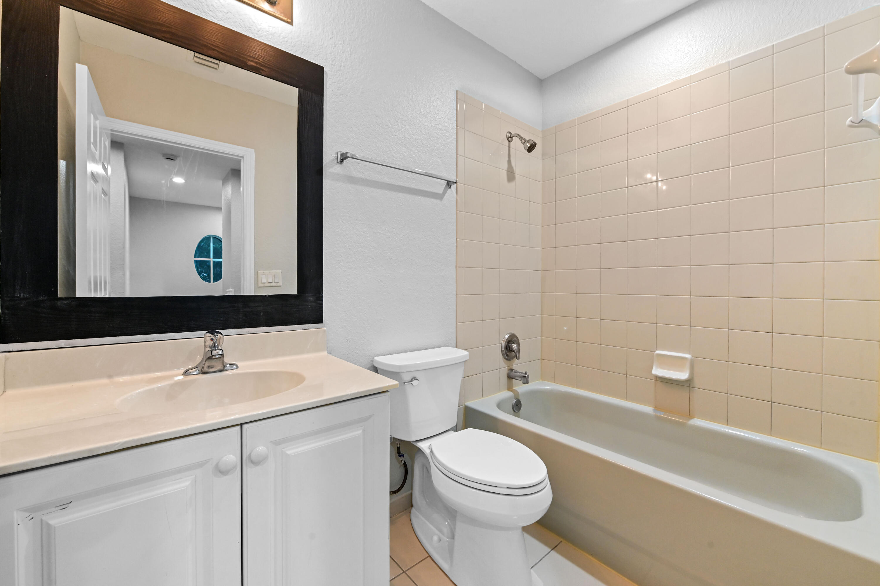 975 Tortuga Drive Riviera Beach, FL 33404 - Photo 20 of 29 a bathroom with a sink a toilet and a mirror