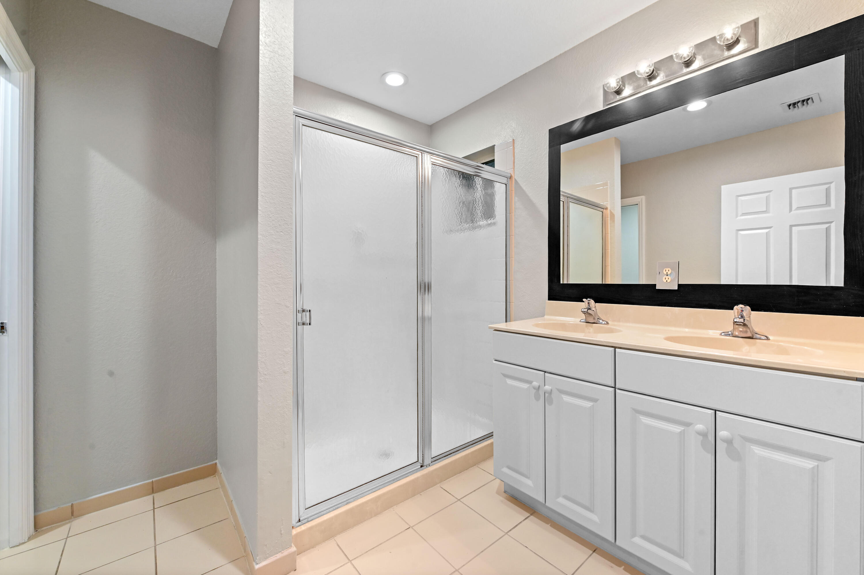 975 Tortuga Drive Riviera Beach, FL 33404 - Photo 24 of 29 a bathroom with a double vanity sink mirror and