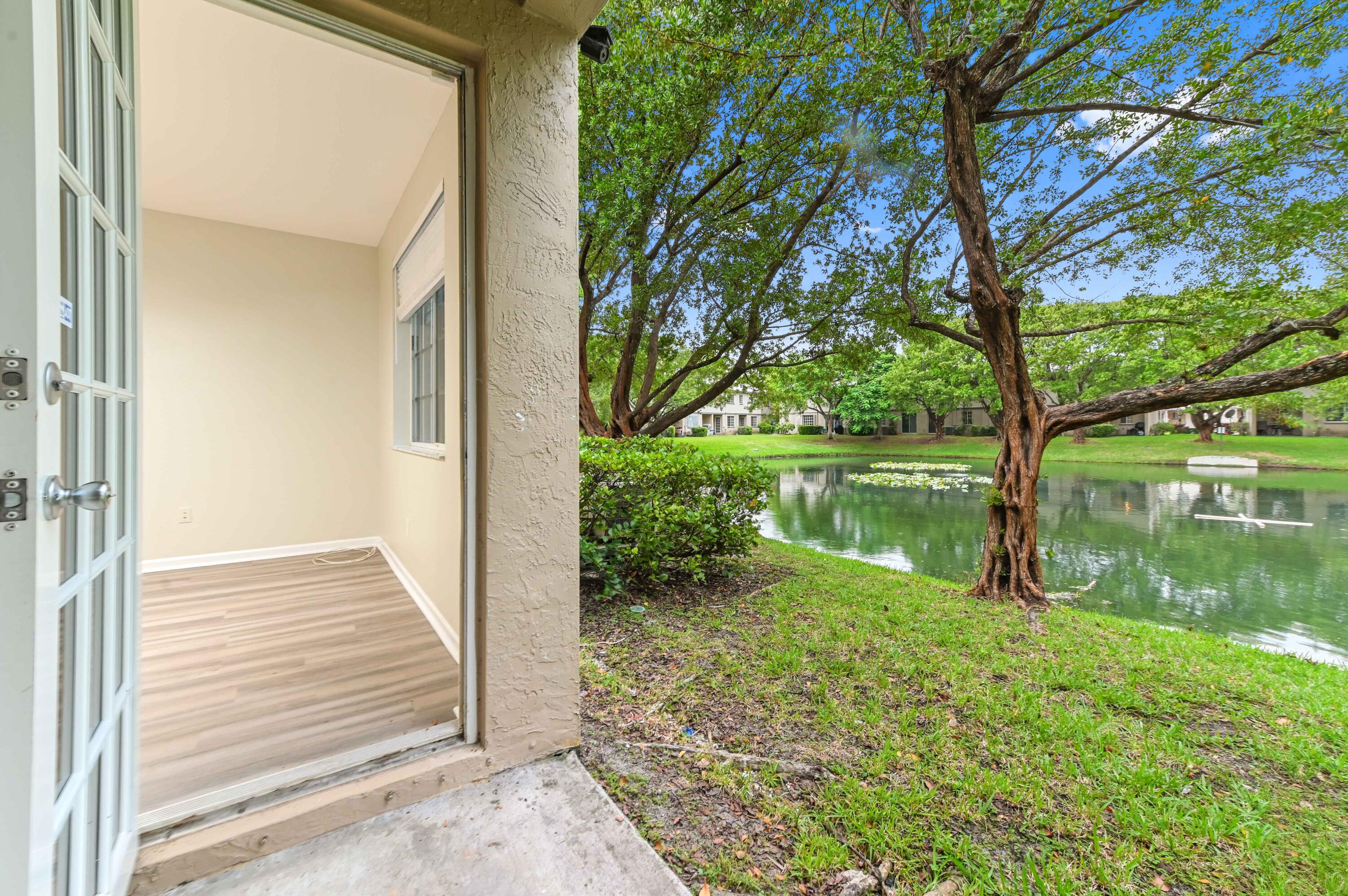 975 Tortuga Drive Riviera Beach, FL 33404 - Photo 26 of 29 a backyard of a house with a lake view