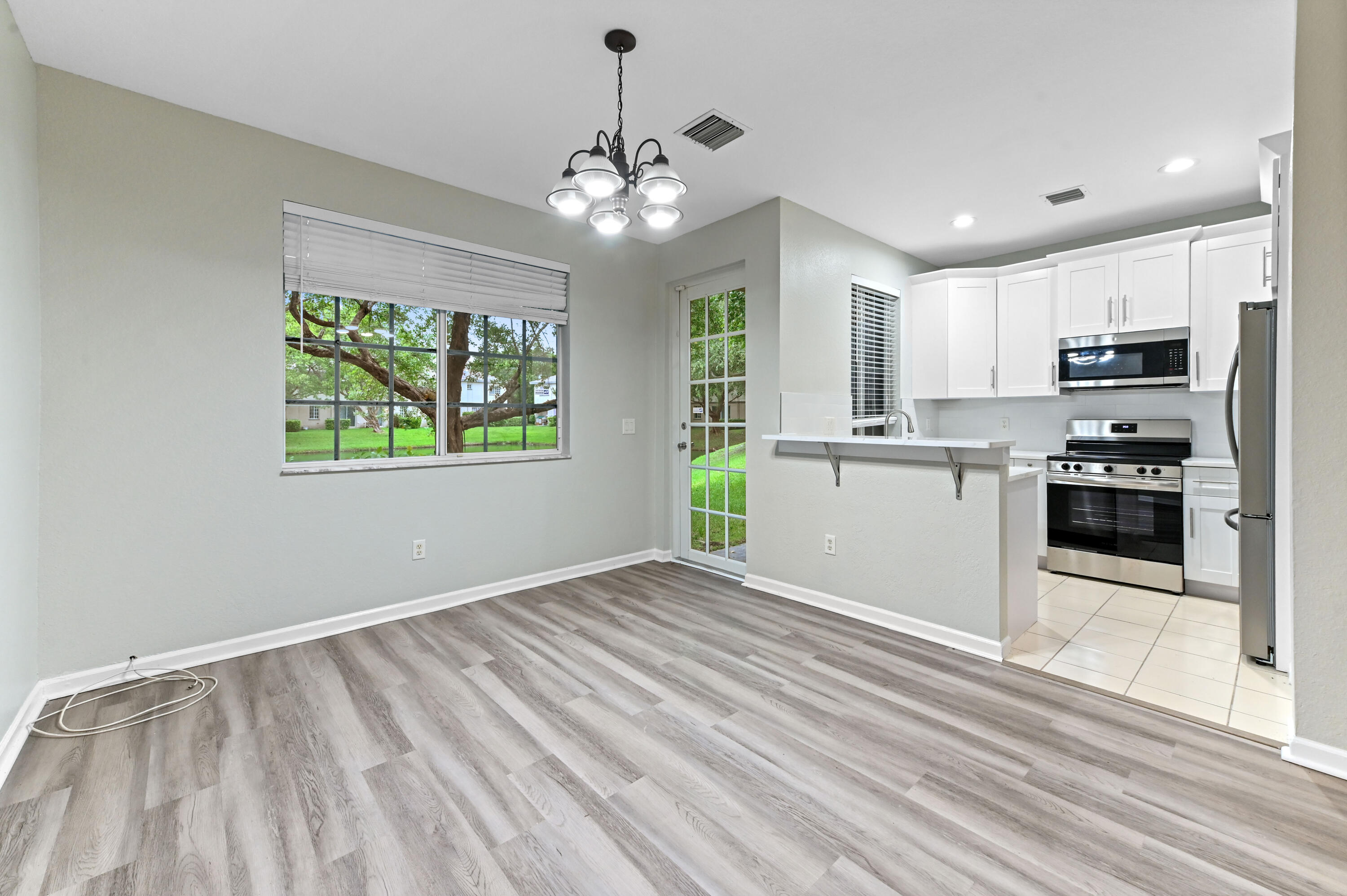 975 Tortuga Drive Riviera Beach, FL 33404 - Photo 7 of 29 a view of a kitchen with microwave and cabinets