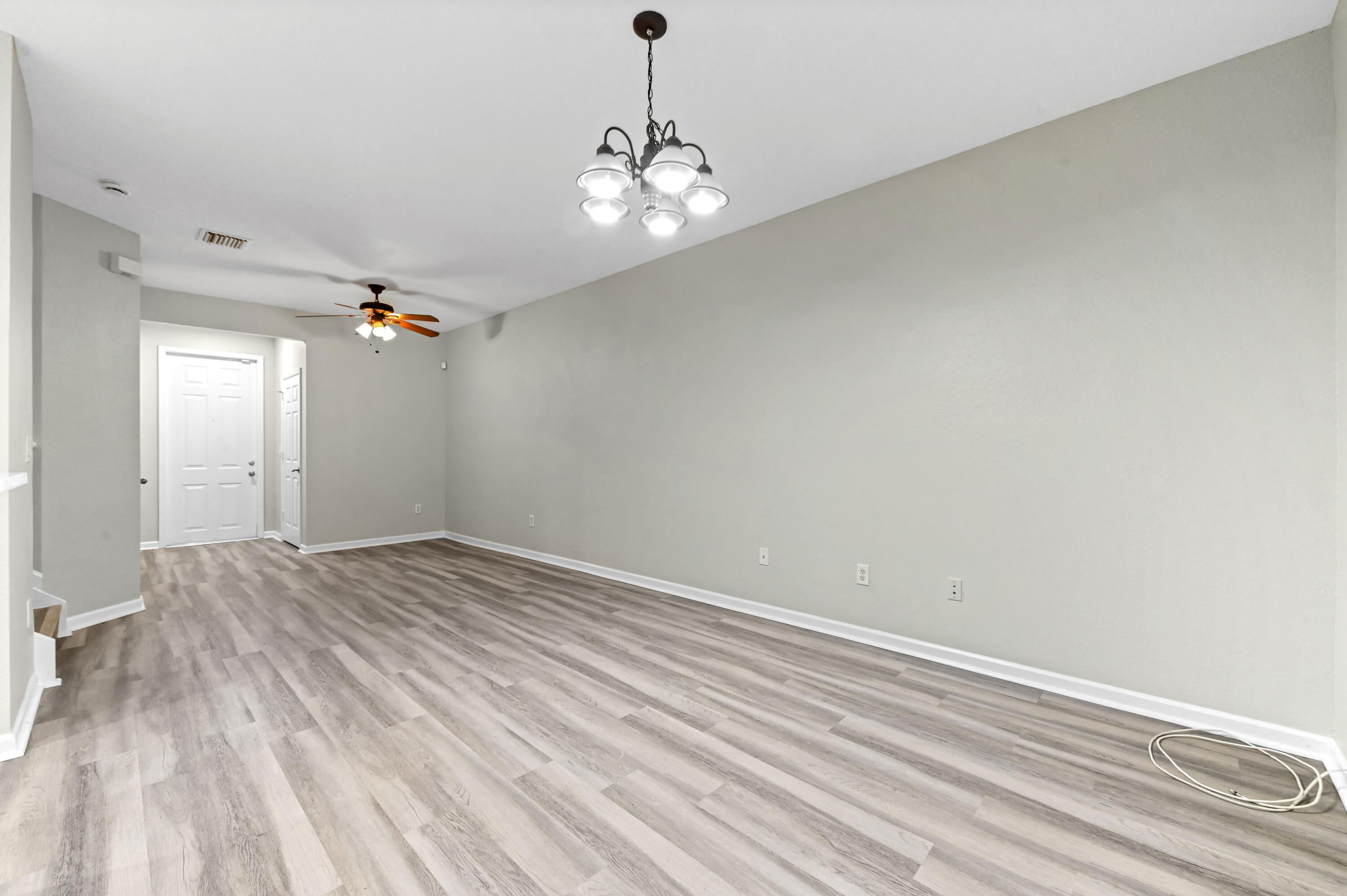 975 Tortuga Drive Riviera Beach, FL 33404 - Photo 9 of 29 wooden floor in an empty room with a window