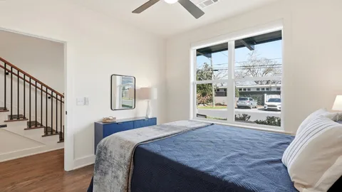 a bedroom with a large bed and a window