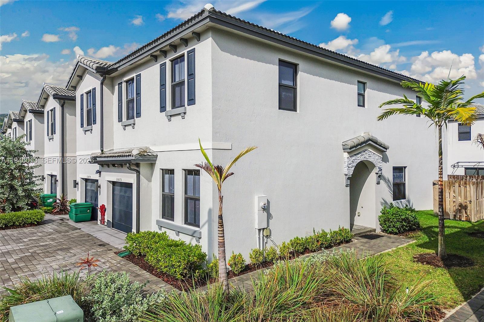 13073 Southwest 286th Street Homestead, FL 33033 - Photo 2 of 53 a front view of a house with a garden
