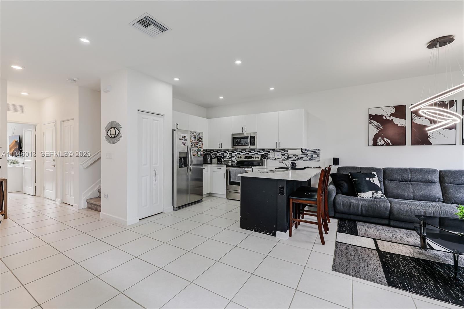 13073 Southwest 286th Street Homestead, FL 33033 - Photo 24 of 53 a kitchen with stainless steel appliances kitchen island granite countertop a refrigerator and a sink