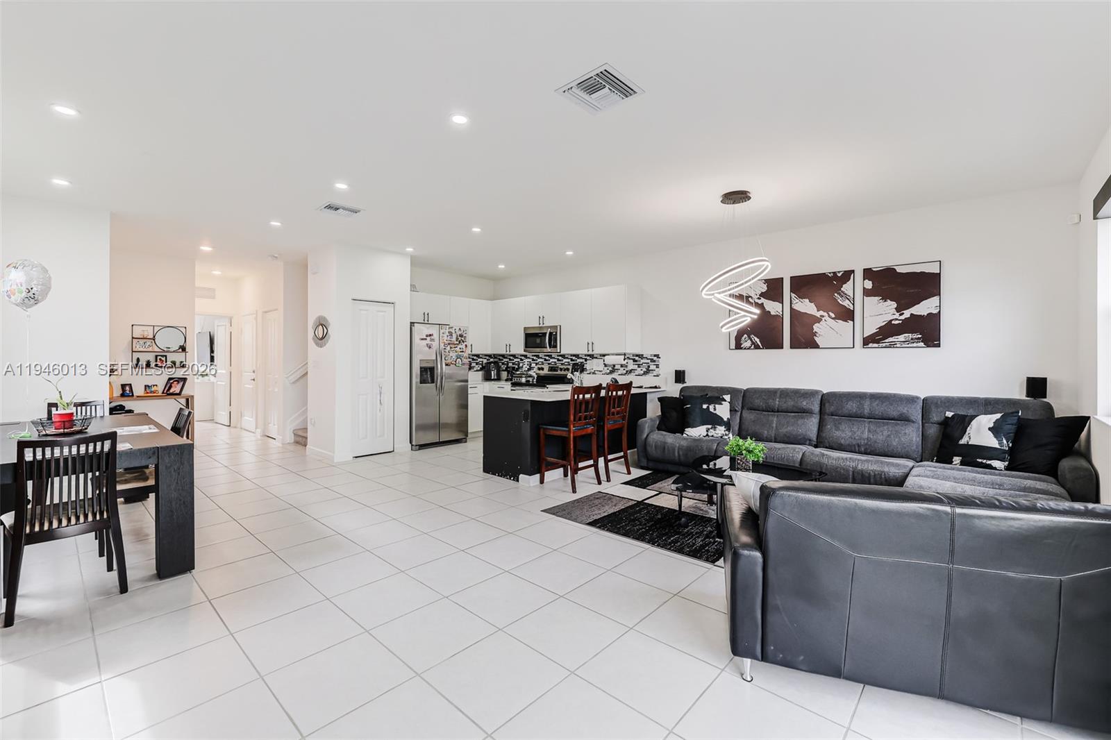 13073 Southwest 286th Street Homestead, FL 33033 - Photo 25 of 53 a living room with lots of furniture and kitchen view