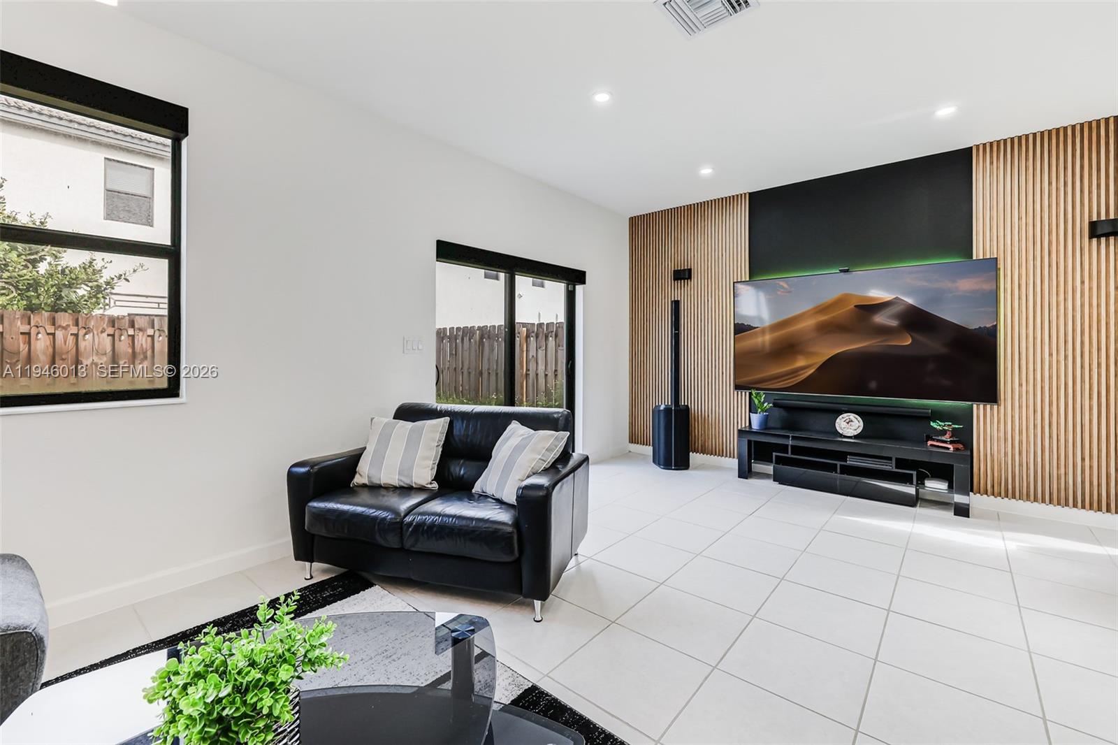 13073 Southwest 286th Street Homestead, FL 33033 - Photo 27 of 53 a living room with furniture and a flat screen tv