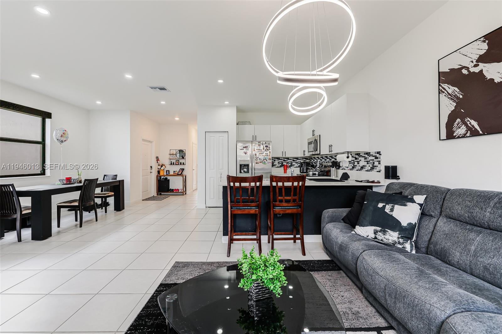 13073 Southwest 286th Street Homestead, FL 33033 - Photo 28 of 53 a living room with furniture and kitchen view