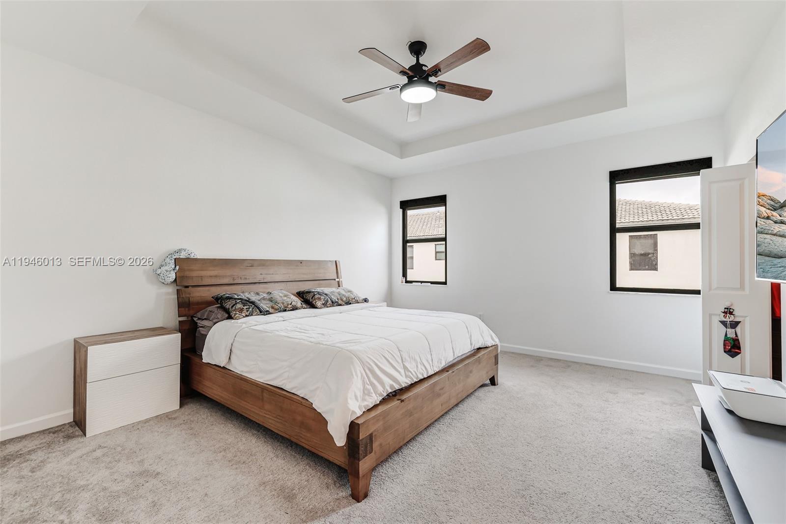13073 Southwest 286th Street Homestead, FL 33033 - Photo 30 of 53 a bedroom with a bed and a chandelier