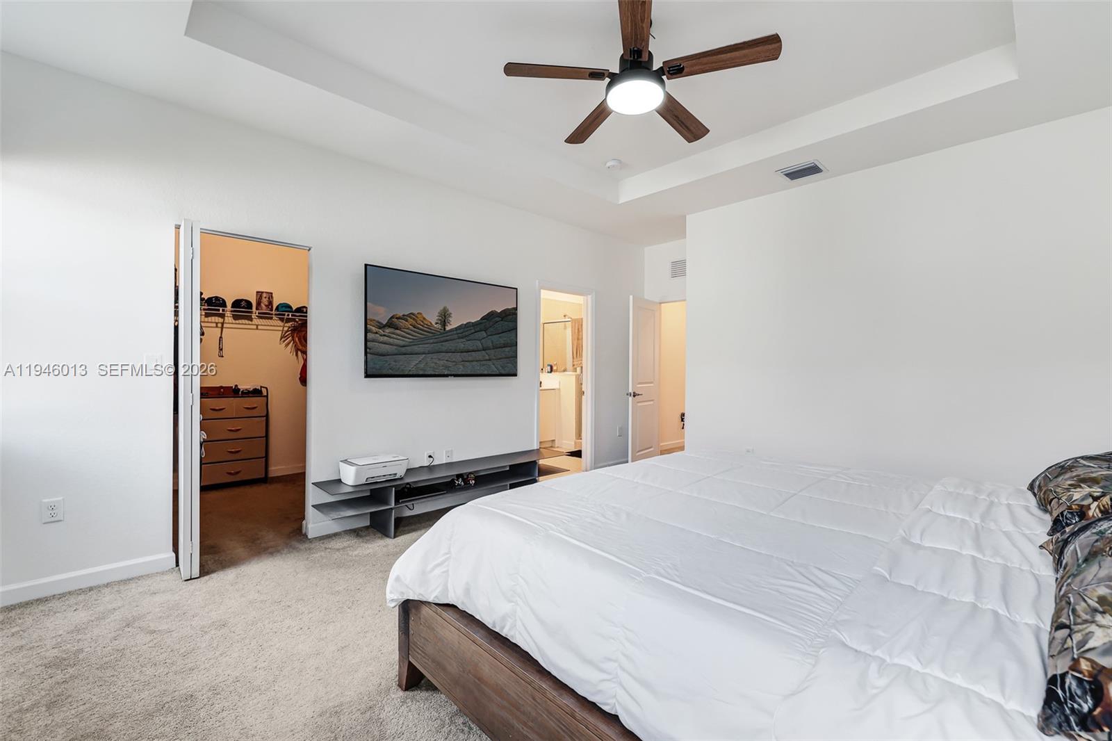 13073 Southwest 286th Street Homestead, FL 33033 - Photo 31 of 53 a bedroom with a bed and a flat screen tv