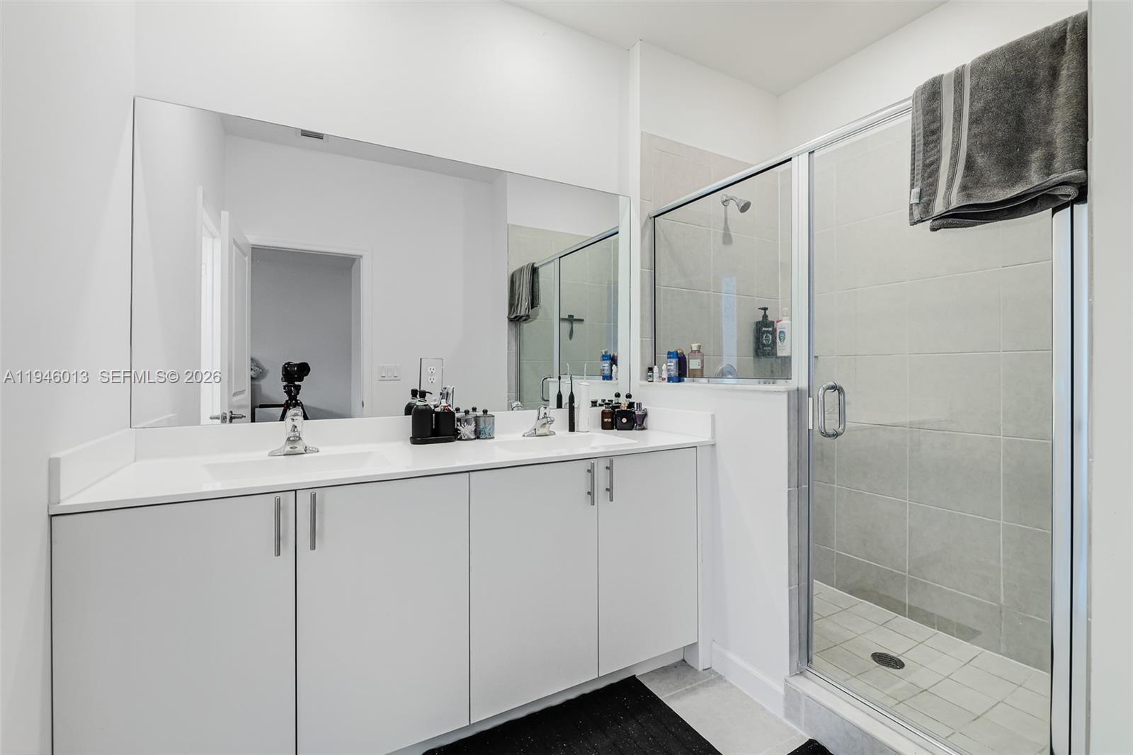 13073 Southwest 286th Street Homestead, FL 33033 - Photo 33 of 53 a bathroom with a double vanity sink a mirror and shower