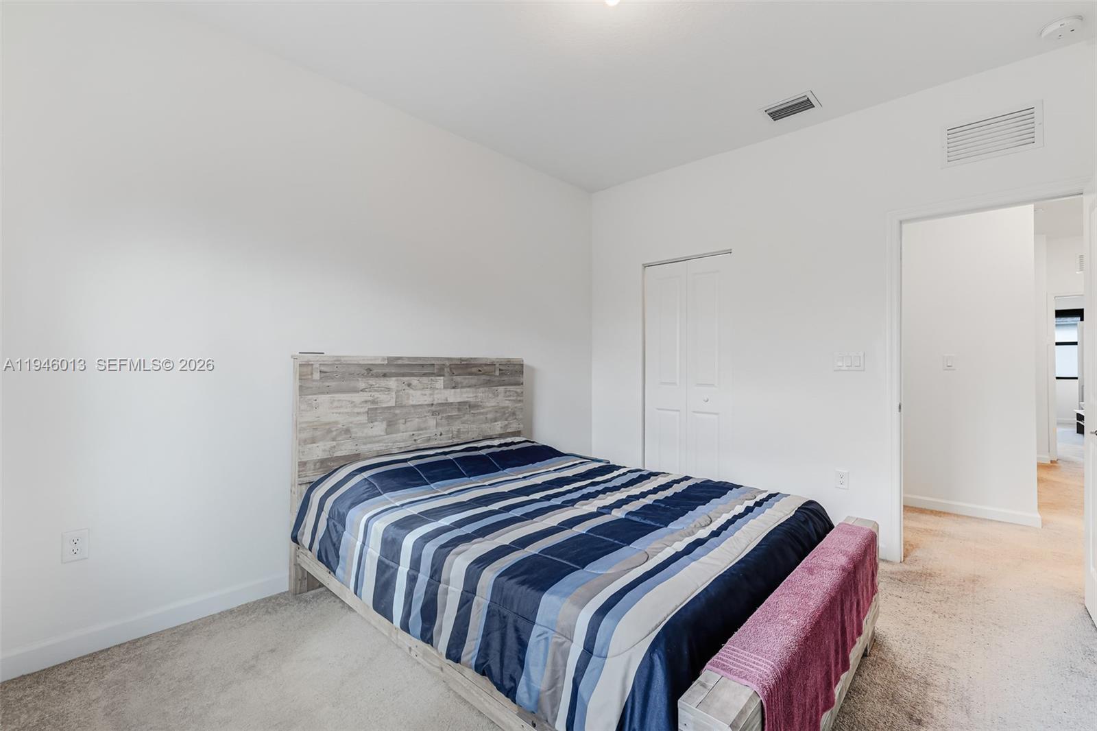 13073 Southwest 286th Street Homestead, FL 33033 - Photo 36 of 53 a bedroom with a bed and a night stand