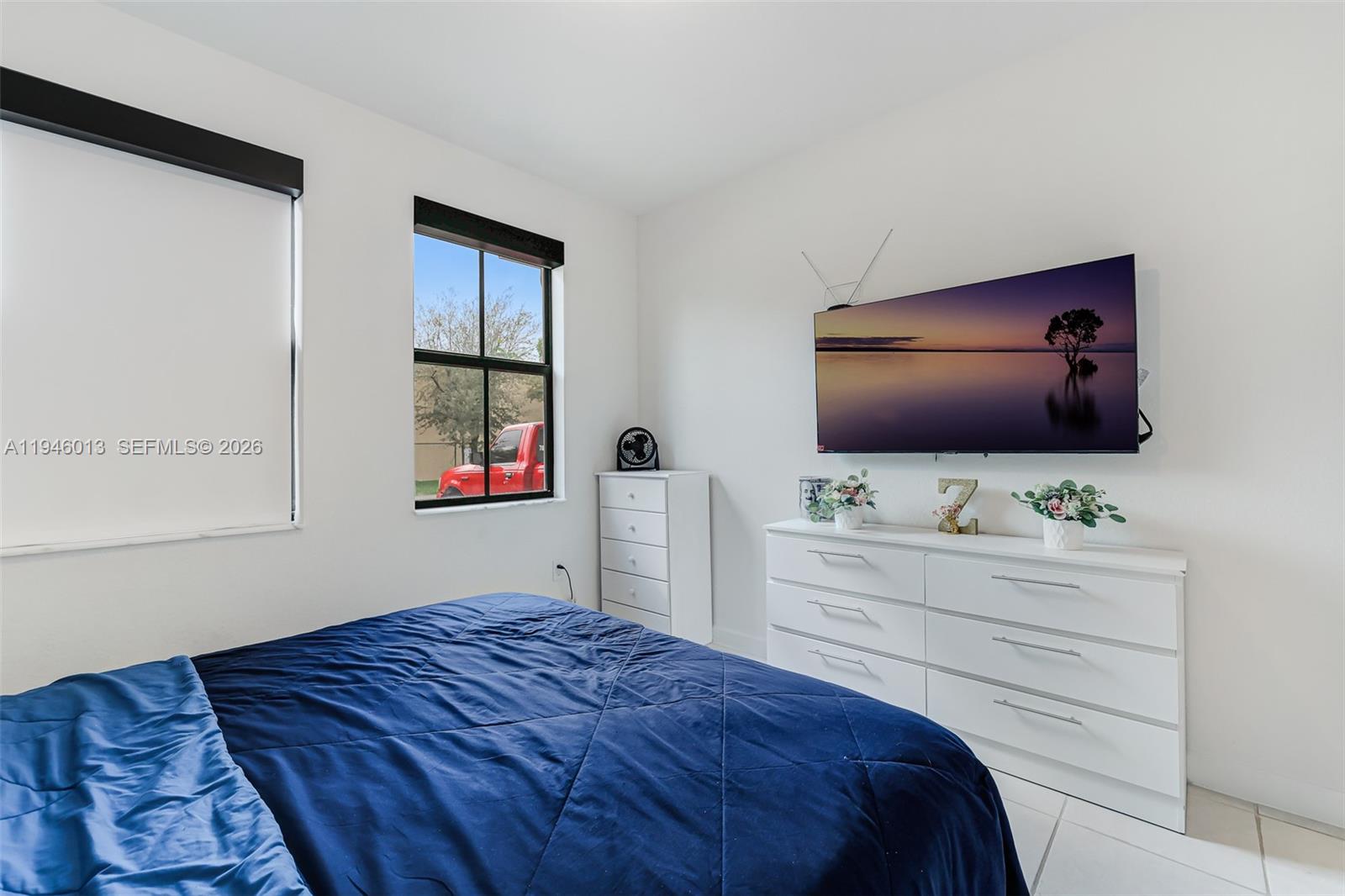 13073 Southwest 286th Street Homestead, FL 33033 - Photo 45 of 53 a bedroom with a bed and a flat screen tv