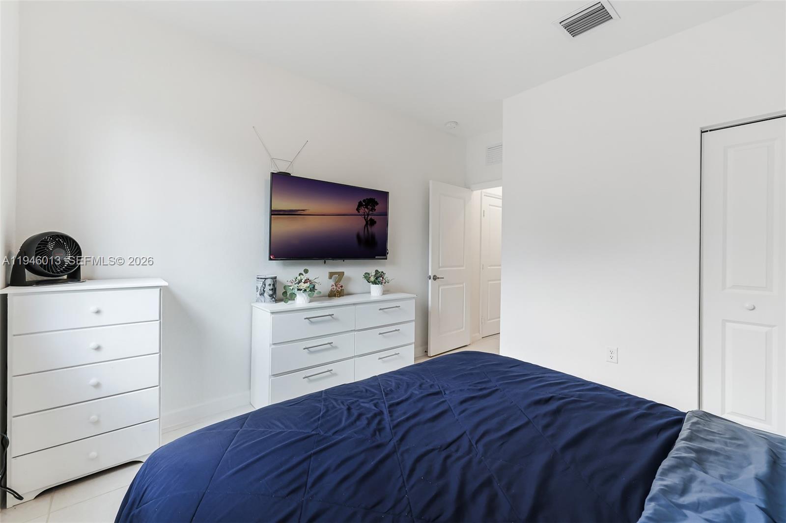 13073 Southwest 286th Street Homestead, FL 33033 - Photo 46 of 53 a bedroom with a bed and a flat screen tv in a dresser