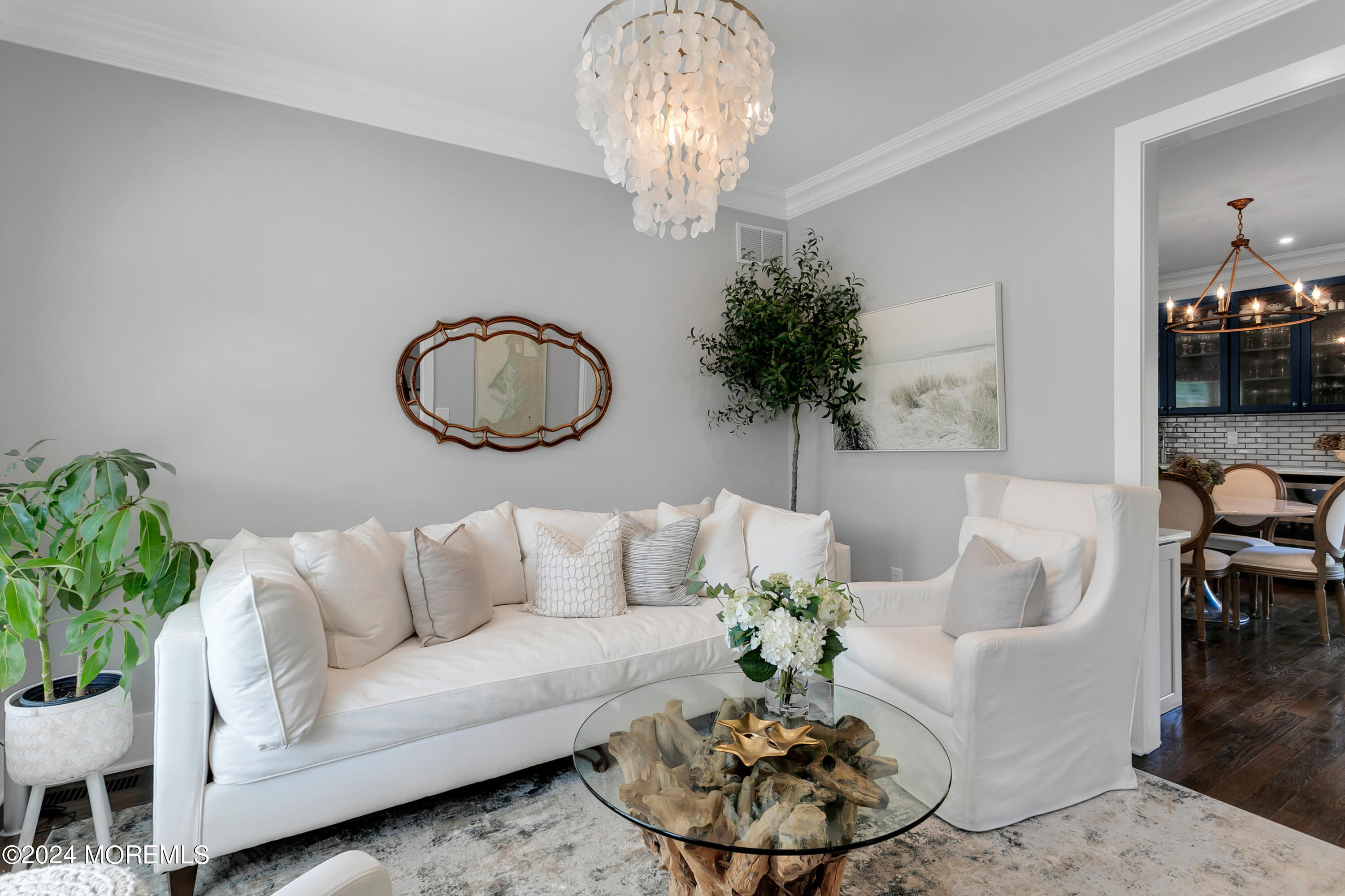 27 Center Street Rumson, NJ 07760 - Photo 20 of 57 a living room with furniture and a chandelier