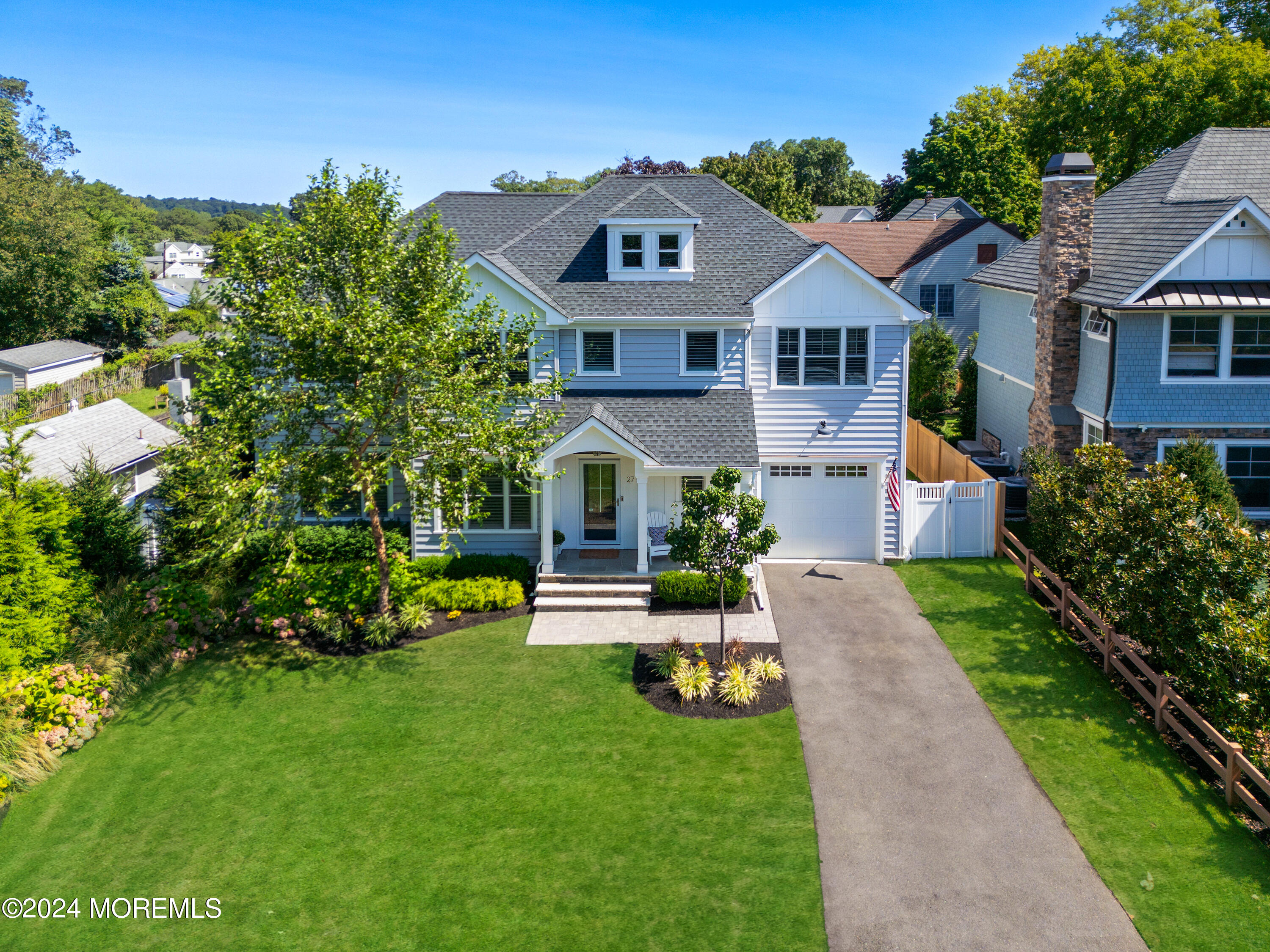27 Center Street Rumson, NJ 07760 - Photo 2 of 57 a front view of a house with a garden