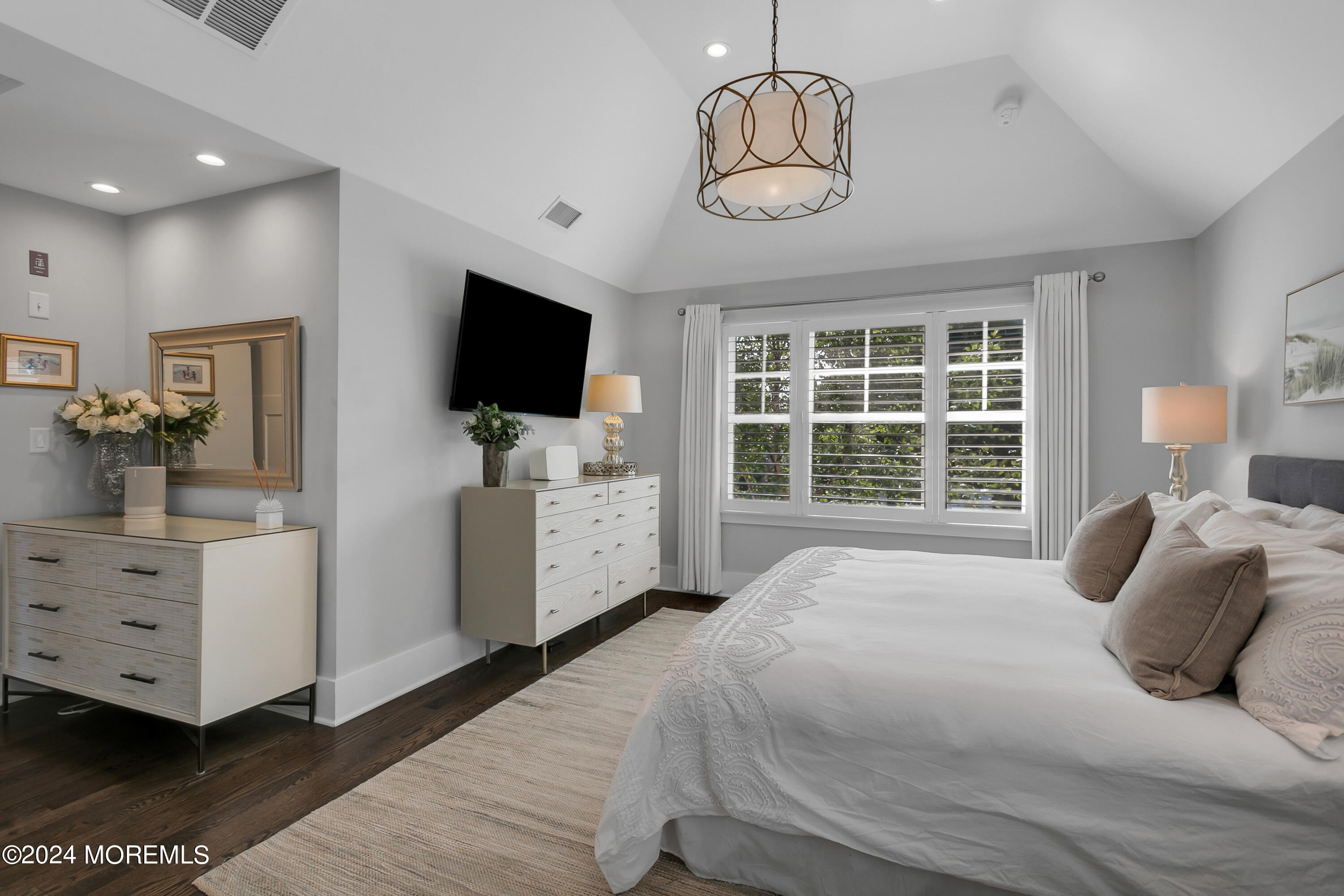 27 Center Street Rumson, NJ 07760 - Photo 25 of 57 a bedroom with a large bed and a flat tv screen on dresser