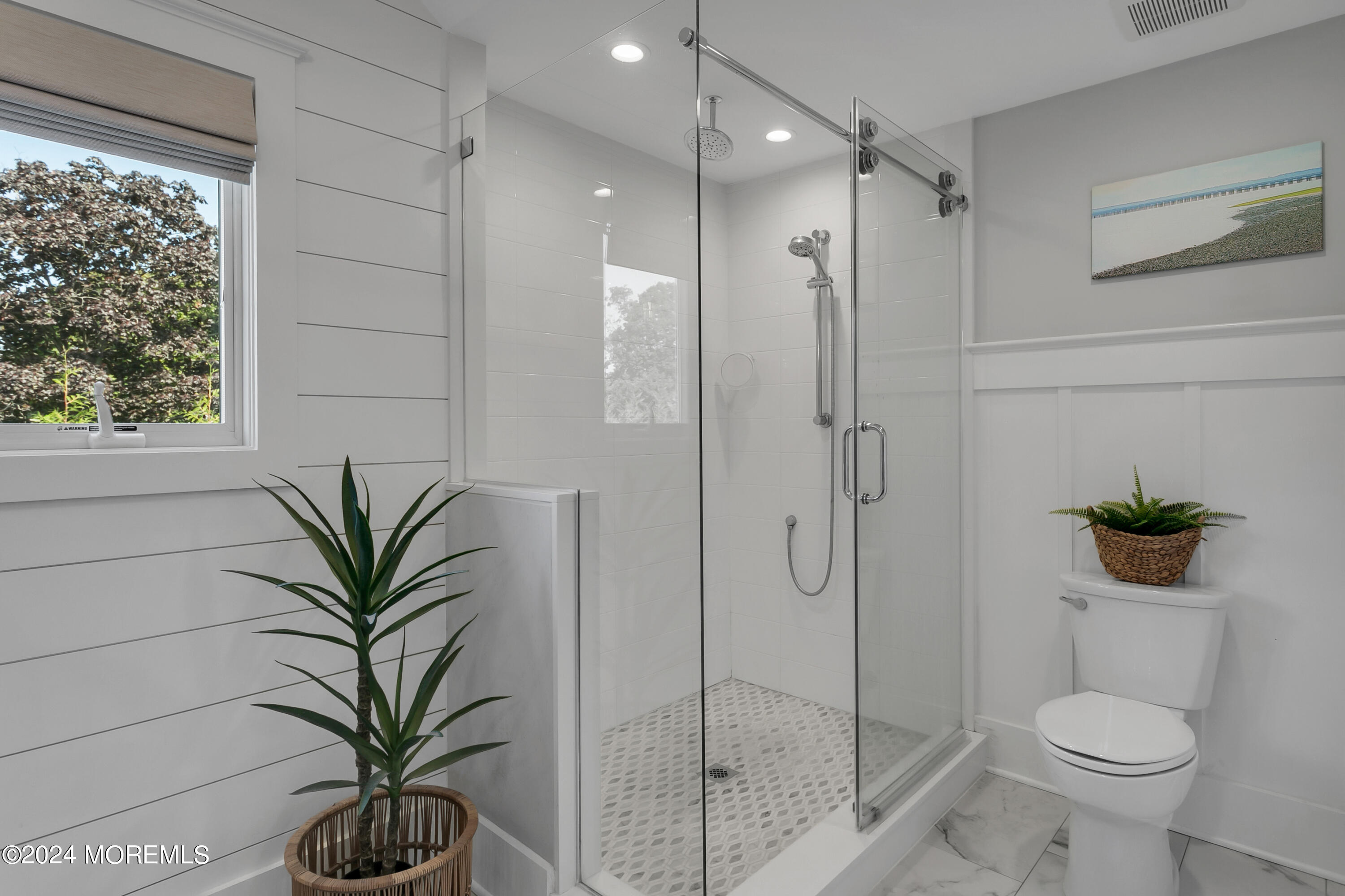 27 Center Street Rumson, NJ 07760 - Photo 29 of 57 a bathroom with a shower a toilet and a window