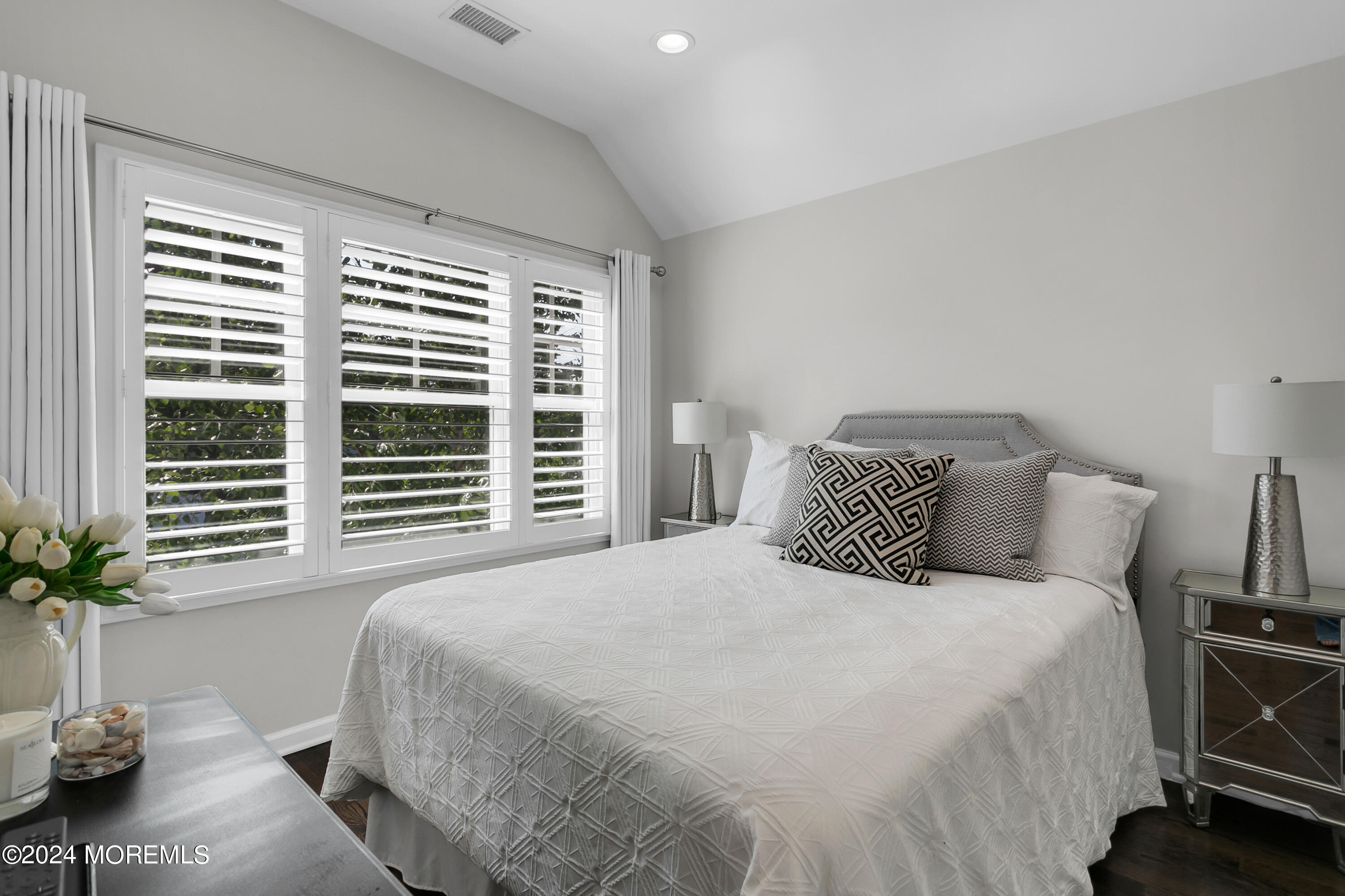 27 Center Street Rumson, NJ 07760 - Photo 31 of 57 a bedroom with a large bed and a potted plant