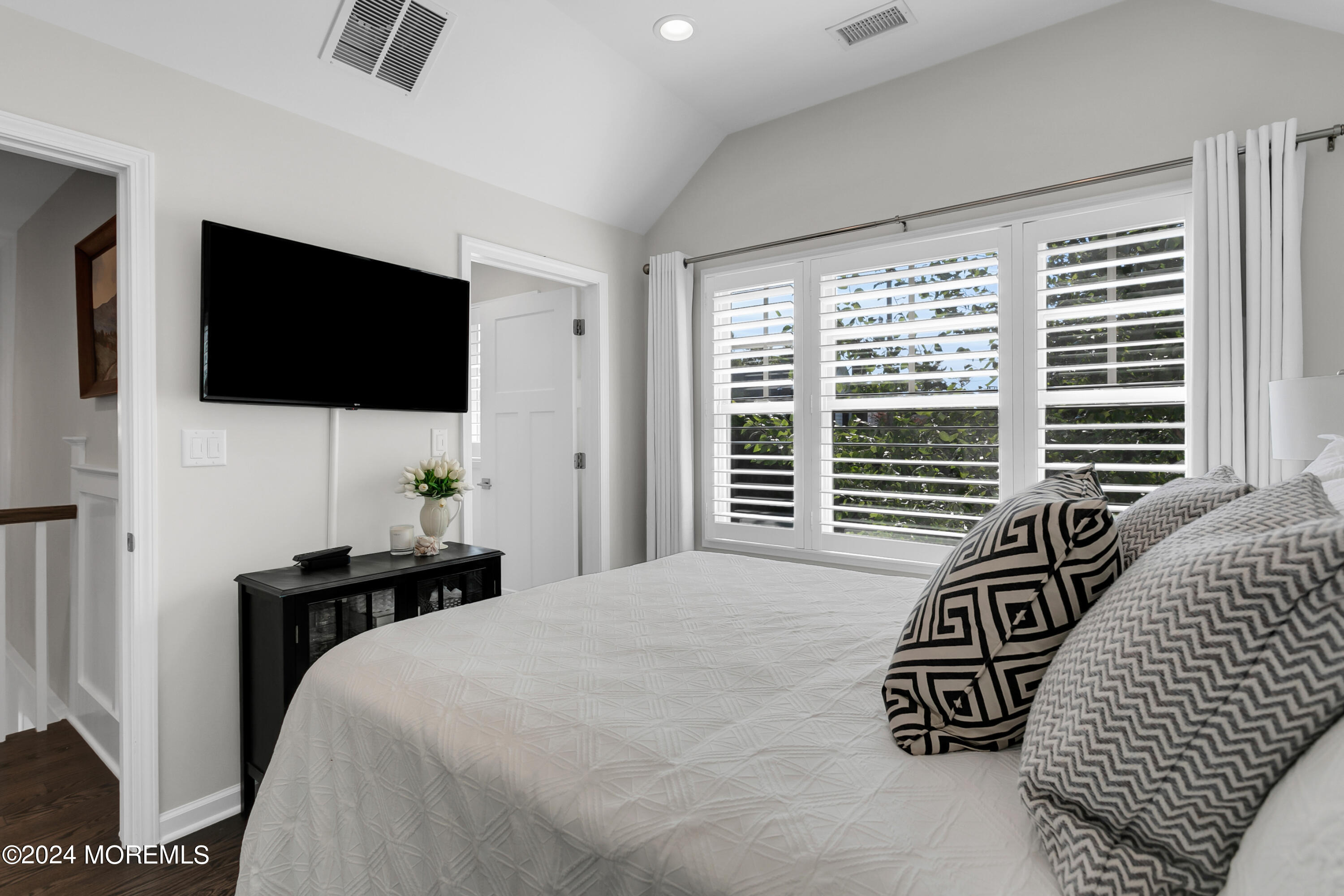 27 Center Street Rumson, NJ 07760 - Photo 32 of 57 a bedroom with a bed and a flat screen tv