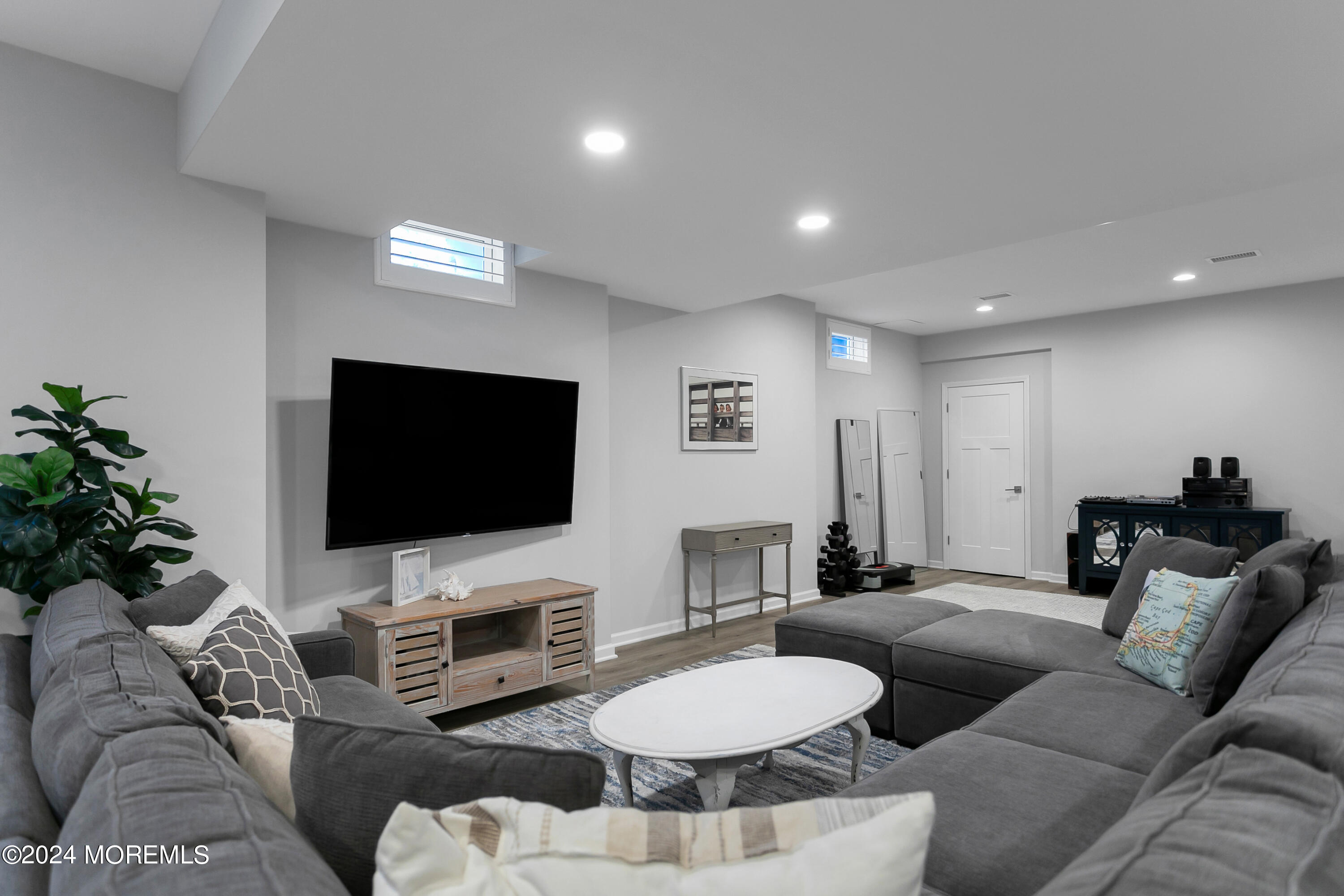 27 Center Street Rumson, NJ 07760 - Photo 41 of 57 a living room with furniture and a flat screen tv