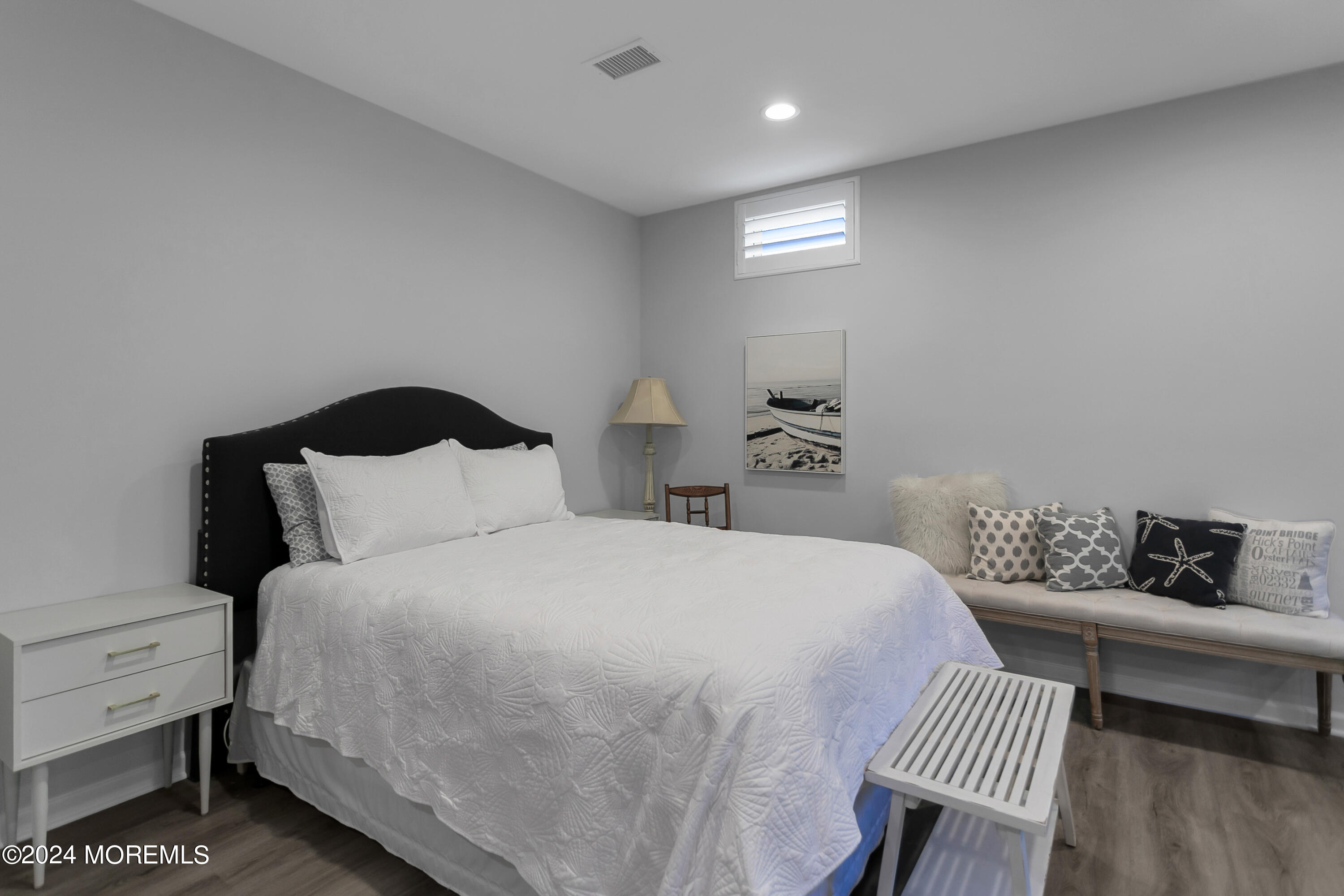 27 Center Street Rumson, NJ 07760 - Photo 42 of 57 a bedroom with a bed and wooden floor