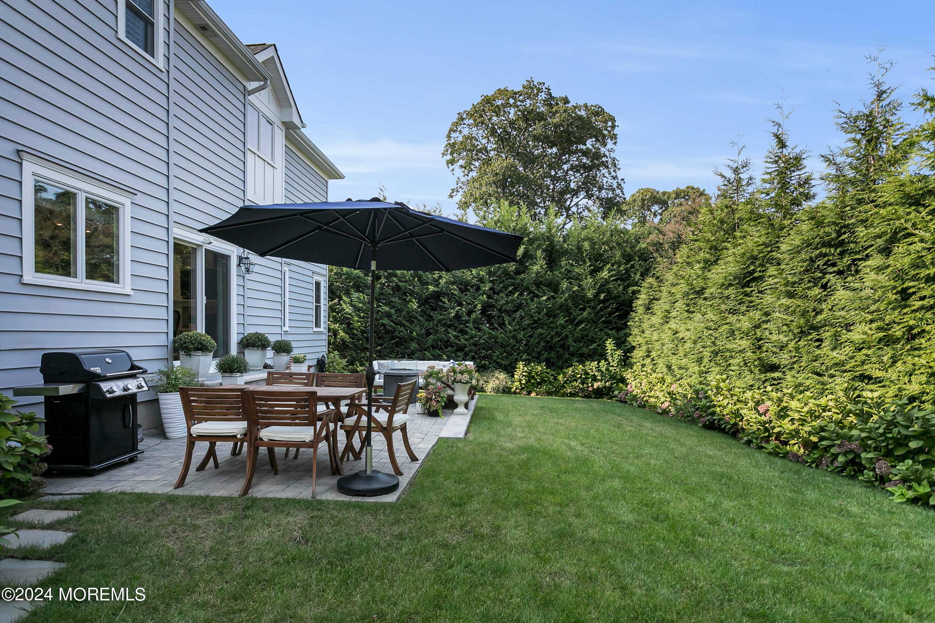 27 Center Street Rumson, NJ 07760 - Photo 50 of 57 a view of a house with backyard sitting area and garden
