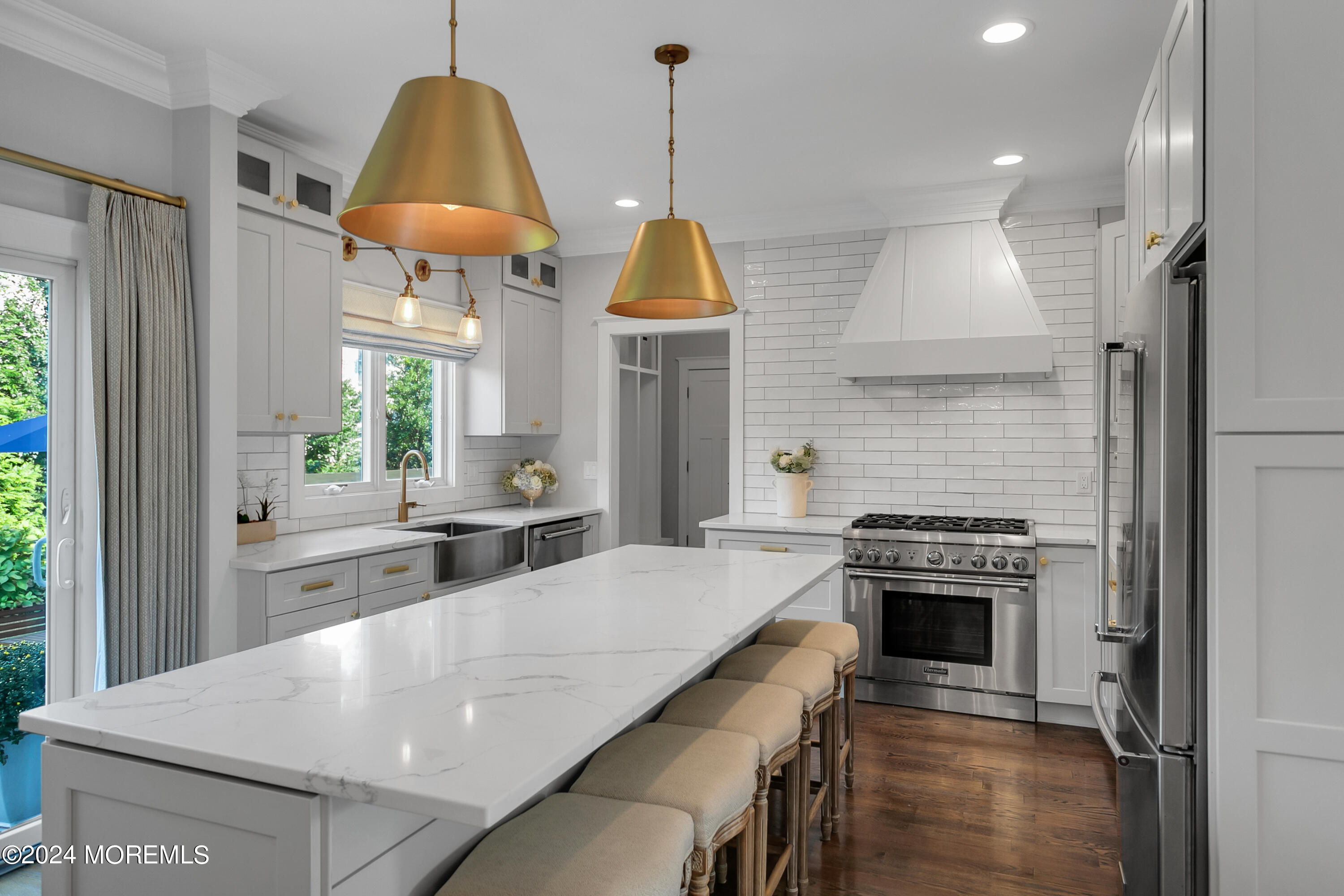 27 Center Street Rumson, NJ 07760 - Photo 8 of 57 a kitchen with kitchen island a stove a counter space a sink and a window
