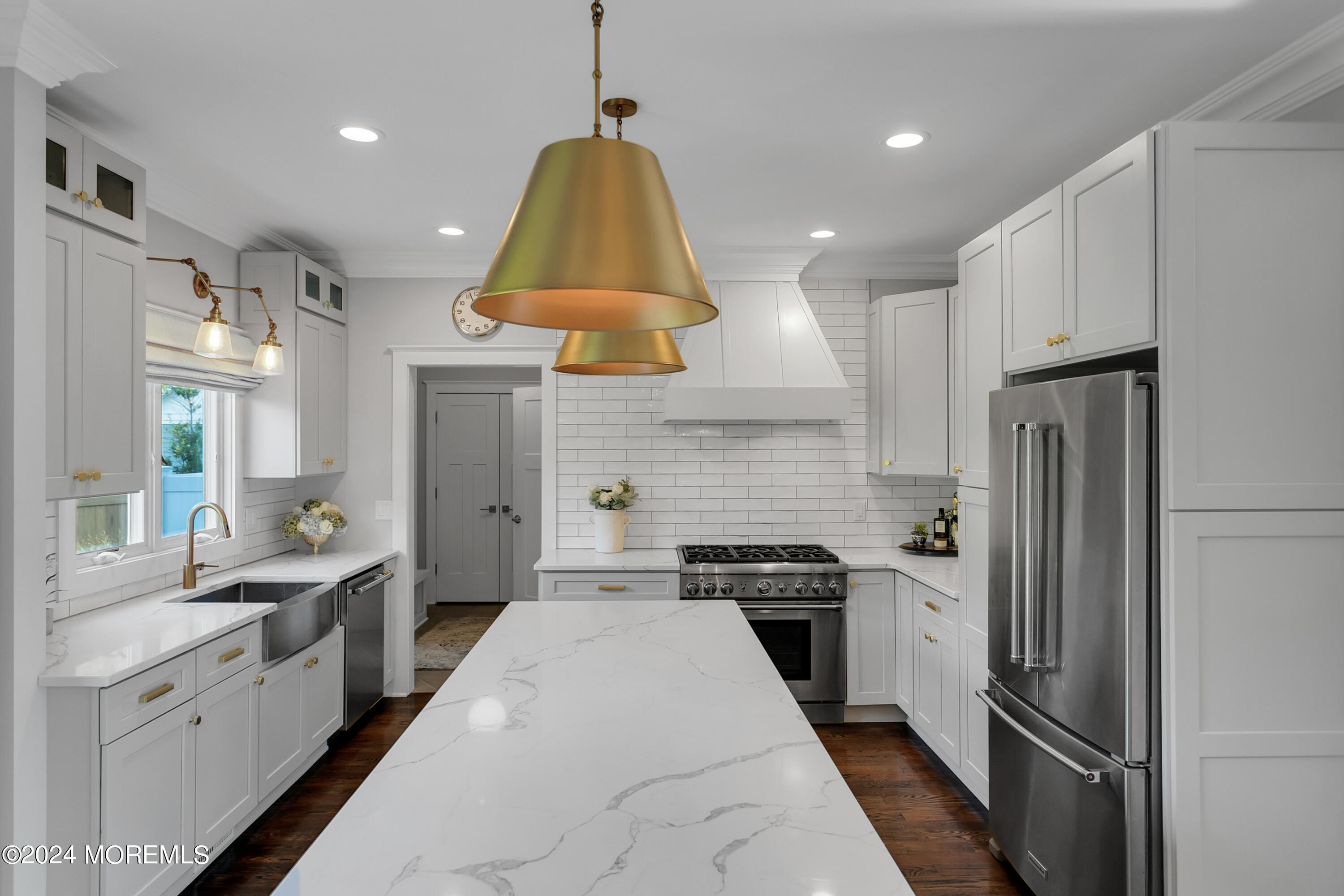 27 Center Street Rumson, NJ 07760 - Photo 9 of 57 a kitchen with stainless steel appliances granite countertop a refrigerator a sink dishwasher a stove and white cabinets with wooden floor