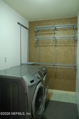 a utility room with a shower and dryer