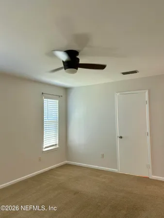 an empty room with windows and closet
