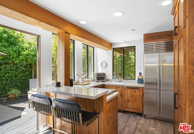 a kitchen with sink cabinets and wooden floor