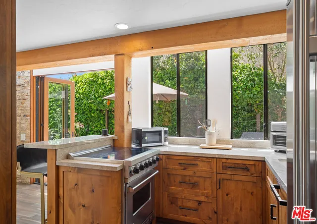 a view of open kitchen with a sink and large window