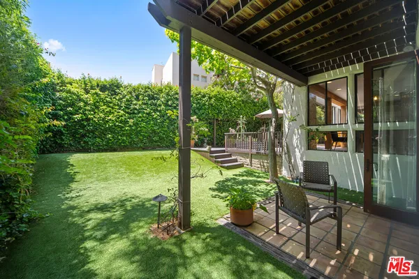 a view of a backyard with sitting area