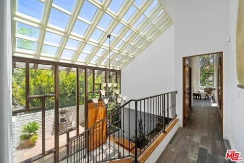 a view of staircase with a large window and wooden floor