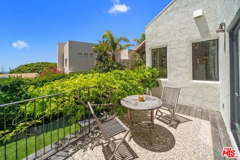 a view of a chair and table in backyard