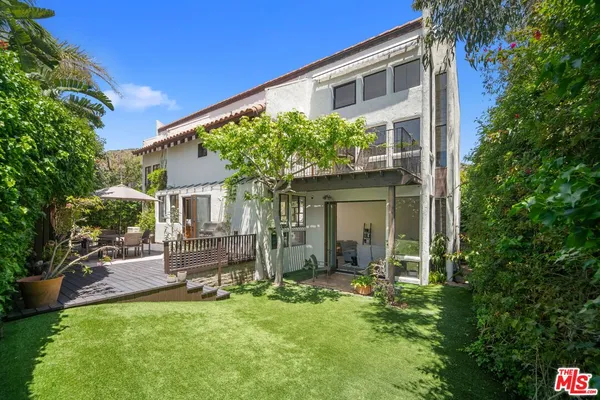a front view of house with yard and outdoor seating