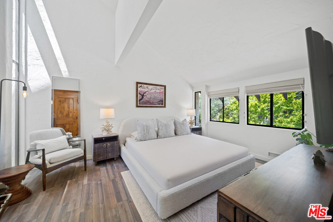 31830 Broad Beach Road Malibu, CA 90265 - Photo 32 of 40 a bedroom with a bed and wooden floor