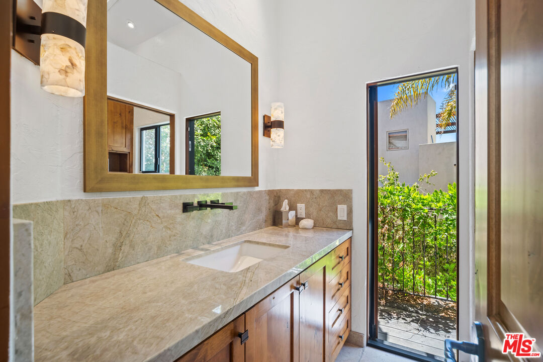 31830 Broad Beach Road Malibu, CA 90265 - Photo 34 of 40 a bathroom with a granite countertop sink and a mirror