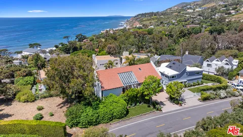 an aerial view of a house with ocean view