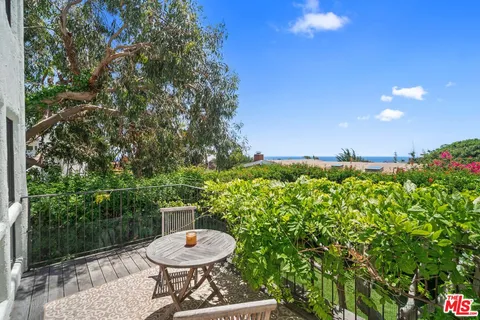 a view of a chairs and table in backyard