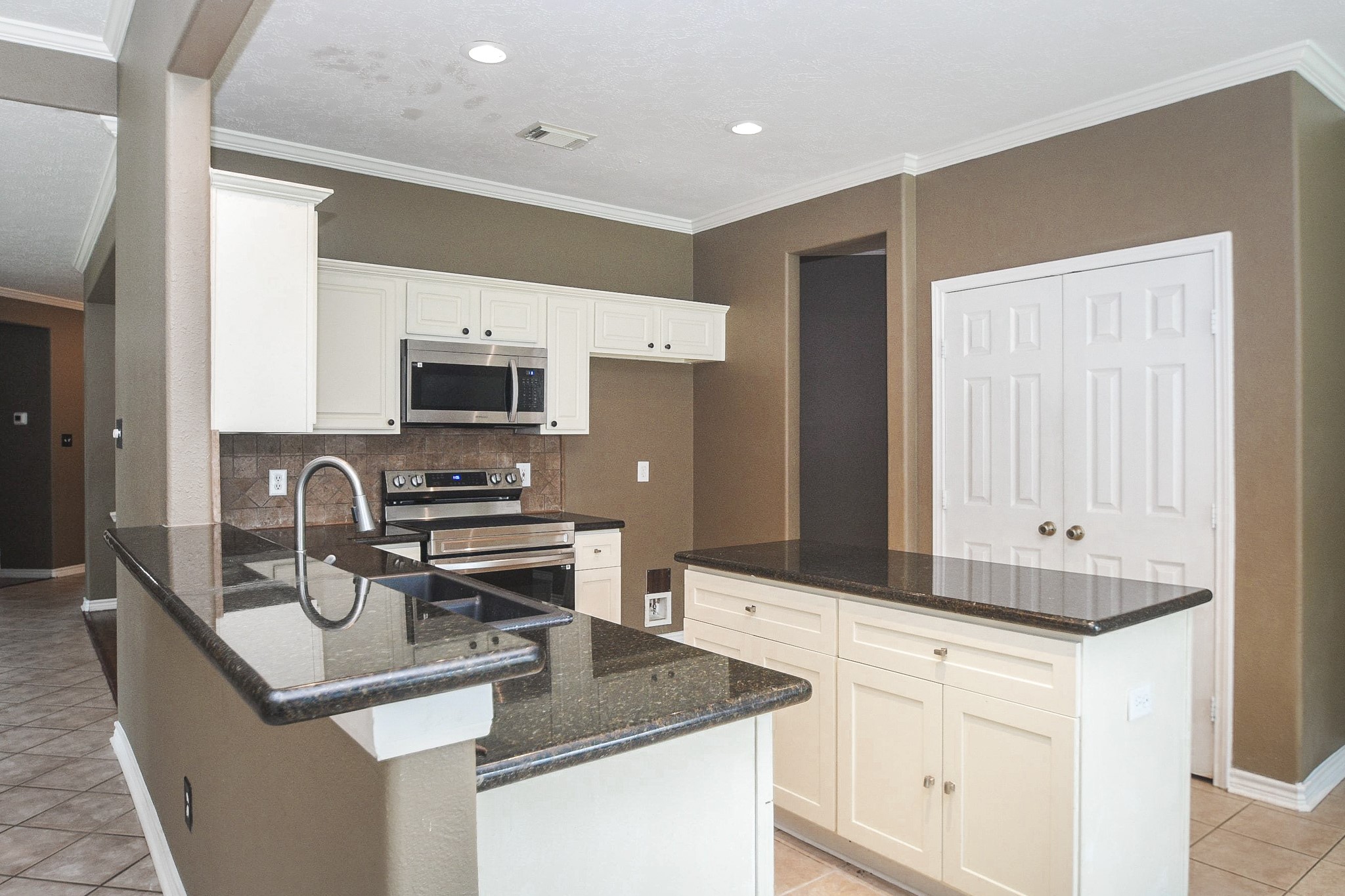 5602 Walkabout Way Katy, TX 77450 - Photo 8 of 33 a kitchen with stainless steel appliances granite countertop a sink stove and refrigerator