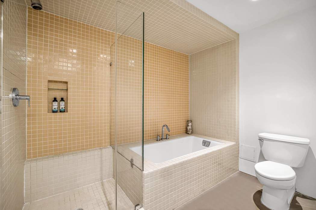 11 West 30th Street, Unit 8F Manhattan, NY 10001 - Photo 10 of 20 a white toilet sitting next to a bath tub