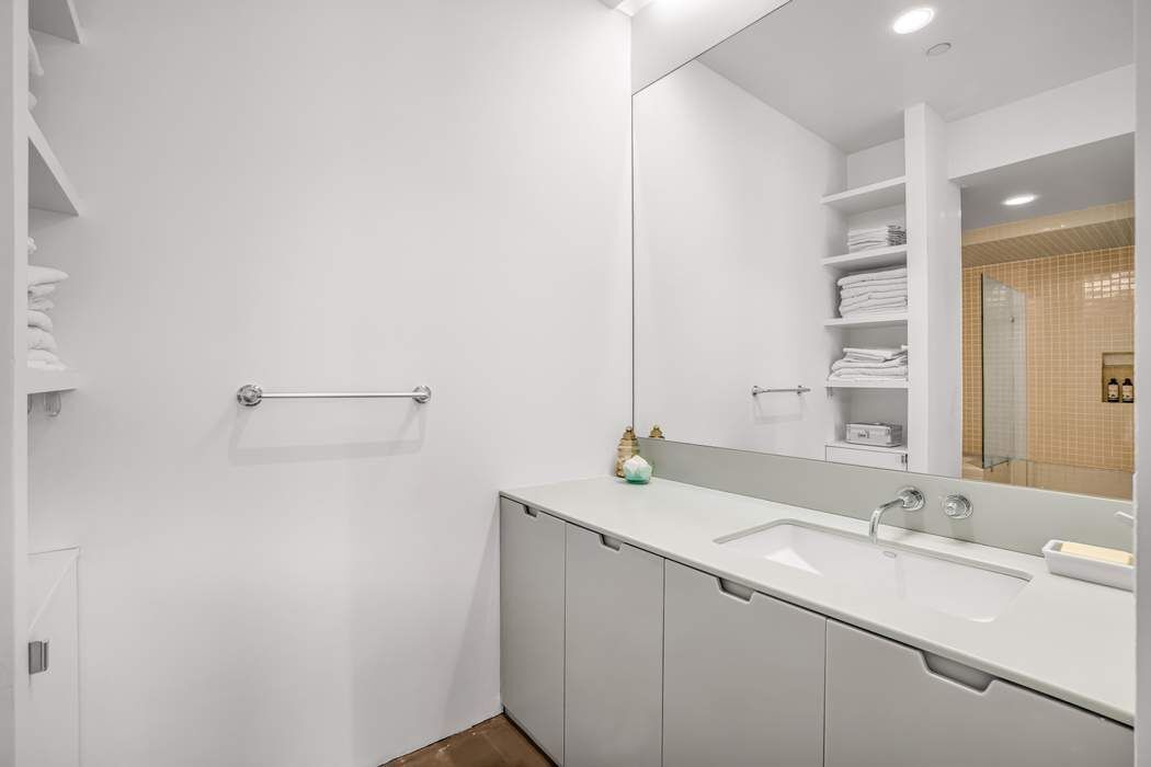 11 West 30th Street, Unit 8F Manhattan, NY 10001 - Photo 11 of 20 a bathroom with a sink and a mirror